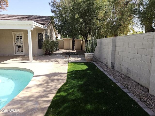 view of yard with a patio area, a fenced backyard, and a fenced in pool