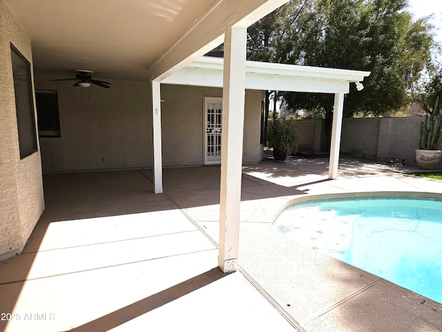 view of swimming pool featuring ceiling fan, a patio, fence, and a fenced in pool