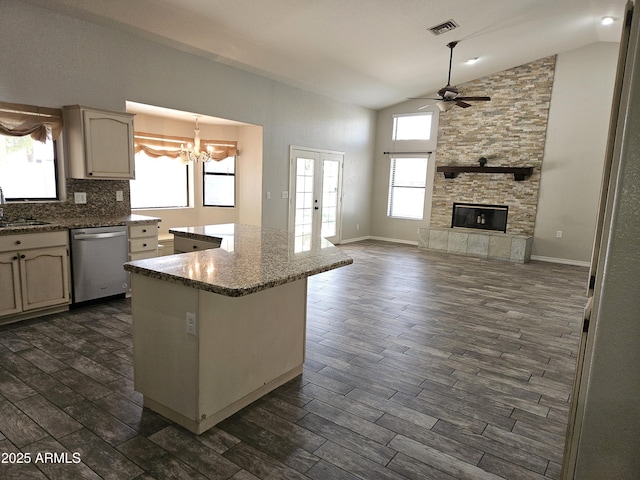 kitchen featuring a fireplace, visible vents, dark wood-type flooring, and stainless steel dishwasher