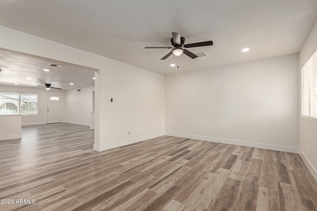 empty room featuring ceiling fan and light hardwood / wood-style floors