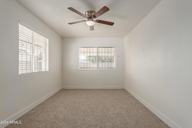 carpeted spare room with ceiling fan