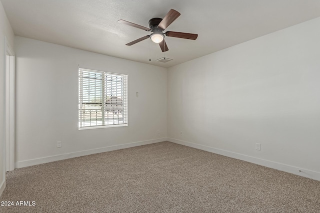 empty room with ceiling fan and carpet