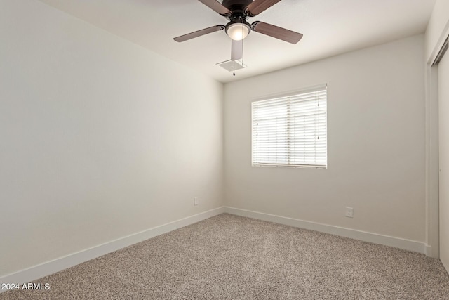 carpeted spare room with ceiling fan