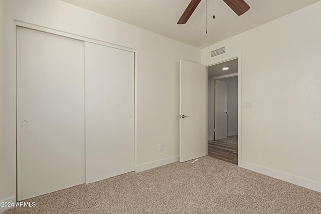 unfurnished bedroom featuring carpet flooring, ceiling fan, and a closet