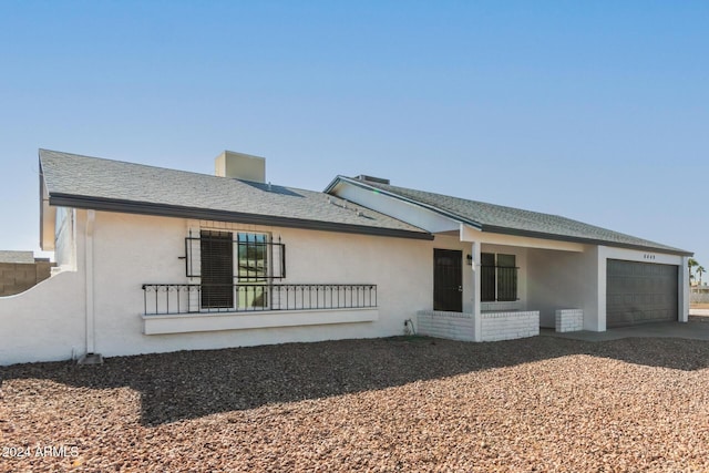 view of front facade featuring covered porch and a garage