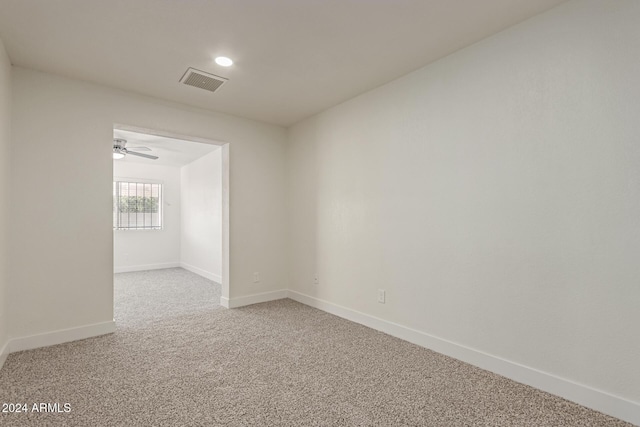 spare room with carpet floors and ceiling fan