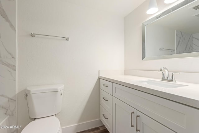 bathroom featuring hardwood / wood-style flooring, vanity, and toilet