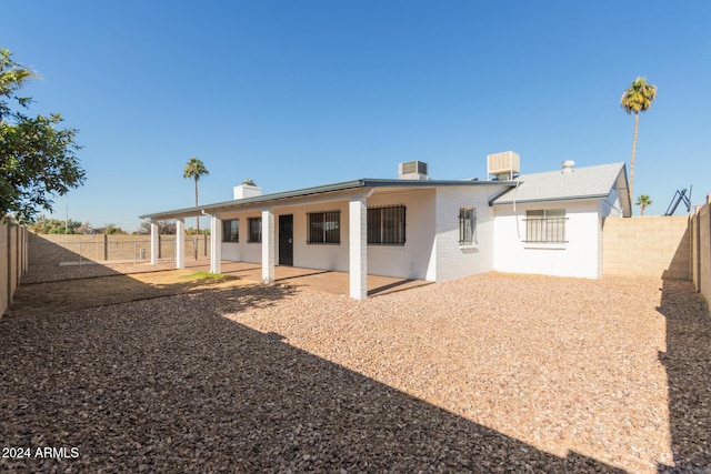 back of house featuring cooling unit and a patio