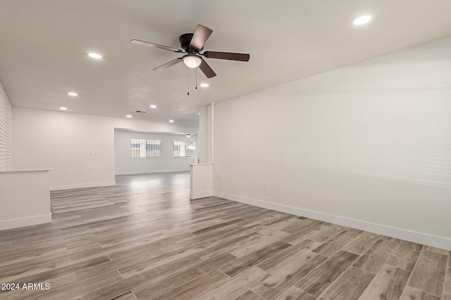 unfurnished living room featuring ceiling fan and light wood-type flooring