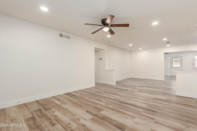 unfurnished room with ceiling fan and light wood-type flooring