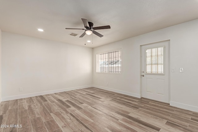 spare room featuring light hardwood / wood-style flooring and ceiling fan