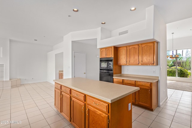 kitchen featuring light countertops, visible vents, dobule oven black, and light tile patterned flooring