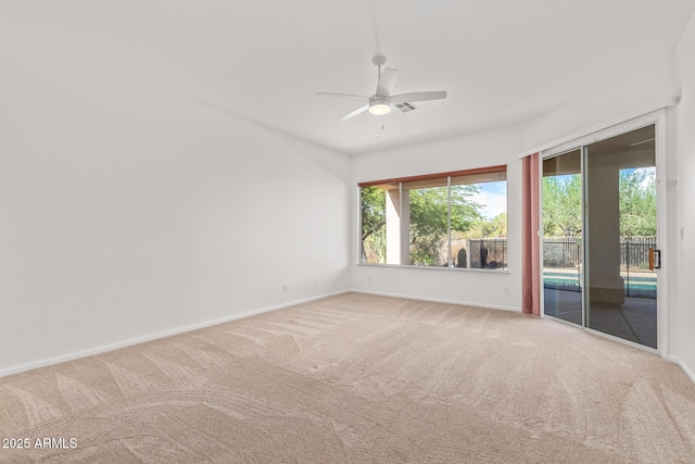 unfurnished room featuring carpet flooring and baseboards