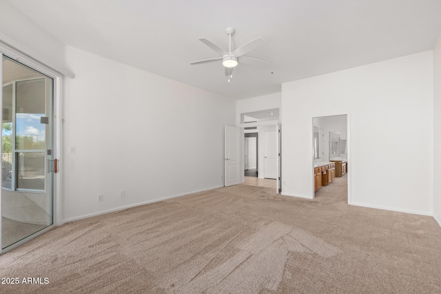 unfurnished bedroom with connected bathroom, light carpet, access to outside, and baseboards