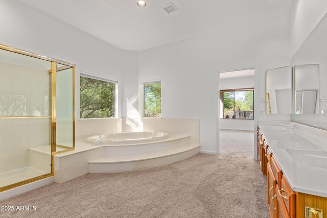 full bath with a sink, a stall shower, double vanity, carpet flooring, and visible vents