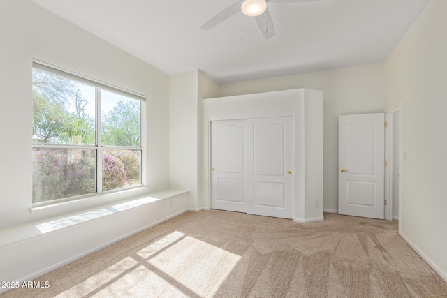 unfurnished bedroom with baseboards, carpet, and ceiling fan