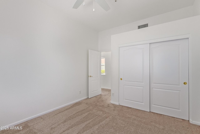unfurnished bedroom featuring visible vents, a ceiling fan, a closet, baseboards, and carpet flooring