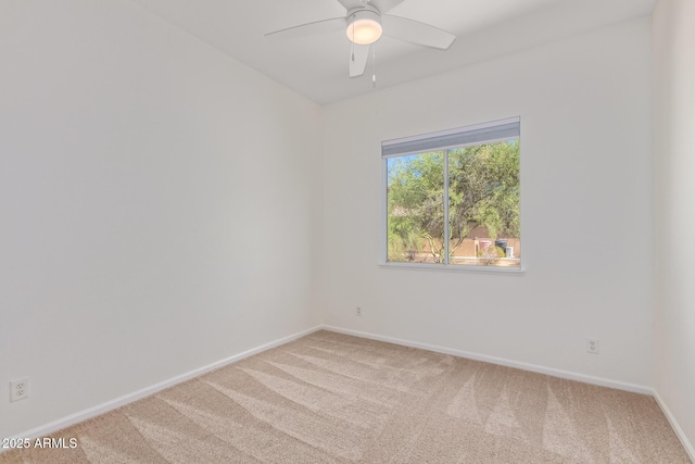 empty room featuring a ceiling fan, baseboards, and light carpet
