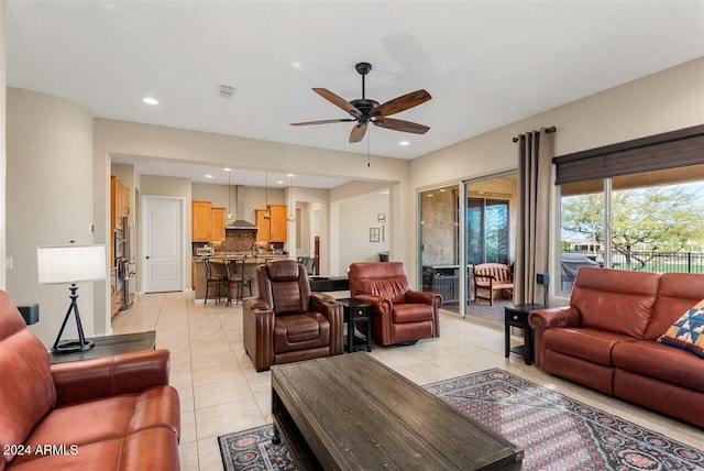 living room with ceiling fan and light tile patterned floors