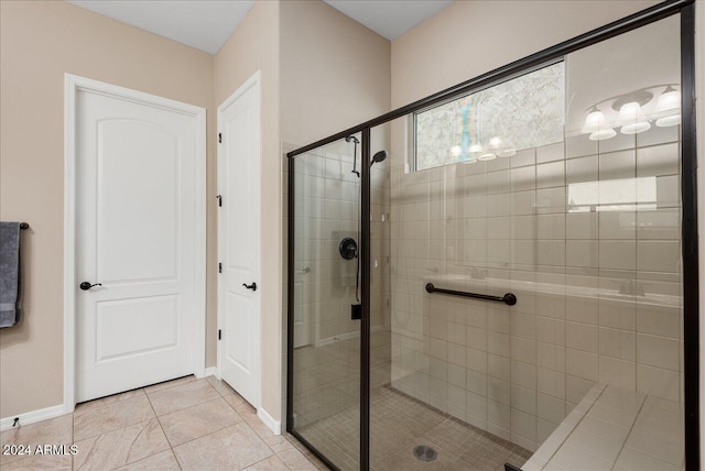 bathroom featuring tile patterned flooring and a shower with door