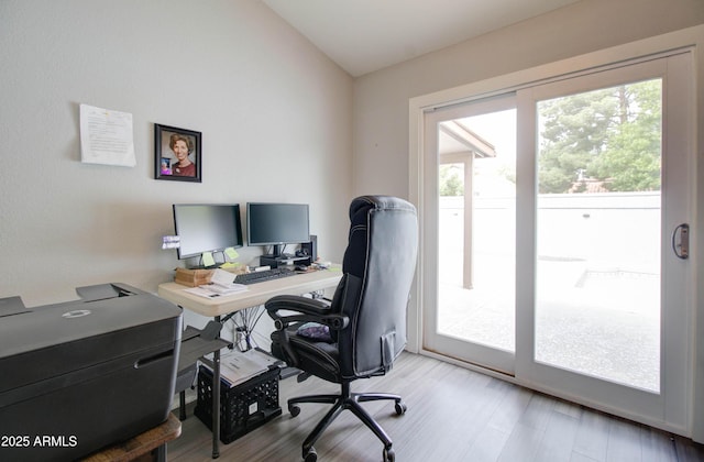 office space featuring vaulted ceiling and wood finished floors