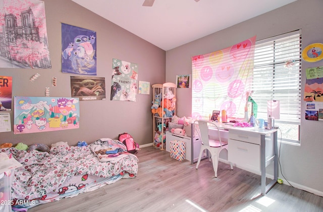 bedroom featuring ceiling fan, baseboards, lofted ceiling, and wood finished floors