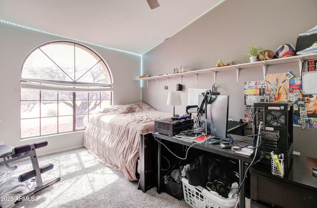 carpeted bedroom with baseboards, a ceiling fan, and vaulted ceiling