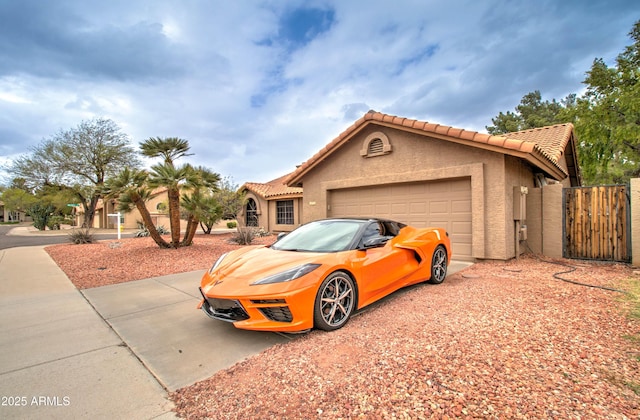 view of front of home featuring stucco siding, concrete driveway, an attached garage, and a tiled roof