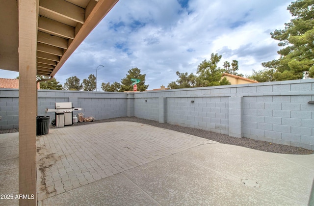 view of patio featuring area for grilling and a fenced backyard