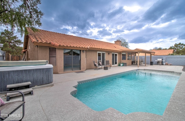 view of swimming pool featuring a patio, a fenced backyard, a grill, a fenced in pool, and a hot tub