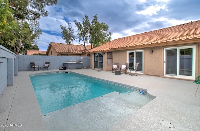 view of pool with a fenced in pool, a hot tub, a fenced backyard, and a patio area