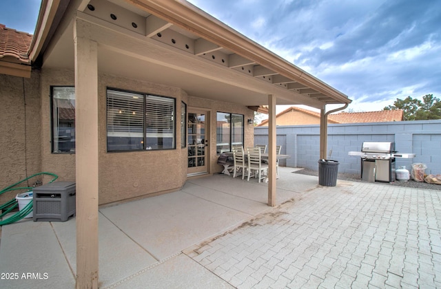 view of patio / terrace featuring a grill and fence