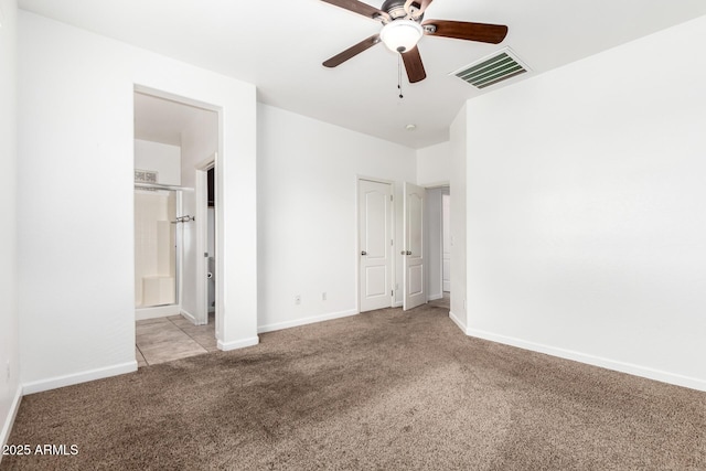 unfurnished bedroom with connected bathroom, light colored carpet, and ceiling fan