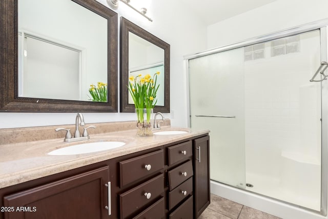 bathroom with tile patterned flooring, vanity, and a shower with door