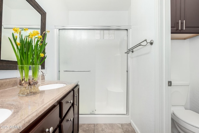 bathroom featuring vanity, toilet, and a shower with door