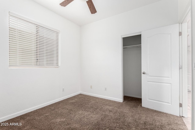 unfurnished bedroom featuring ceiling fan, a closet, and carpet