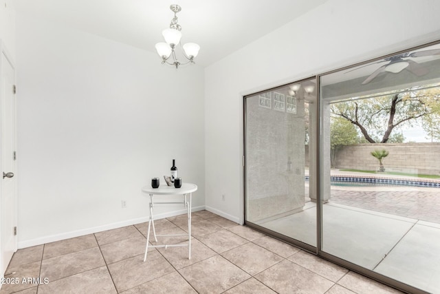 interior space with light tile patterned flooring and ceiling fan with notable chandelier