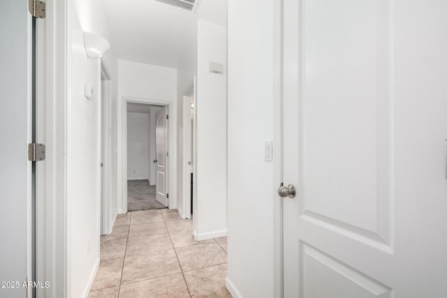 corridor featuring light tile patterned floors