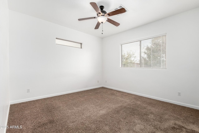 carpeted spare room featuring ceiling fan