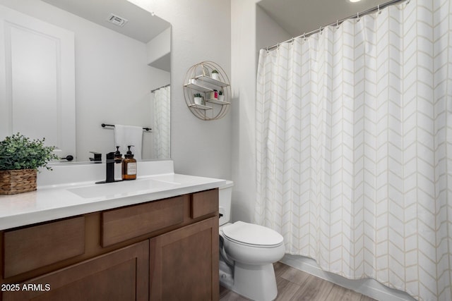 bathroom featuring hardwood / wood-style floors, toilet, and vanity