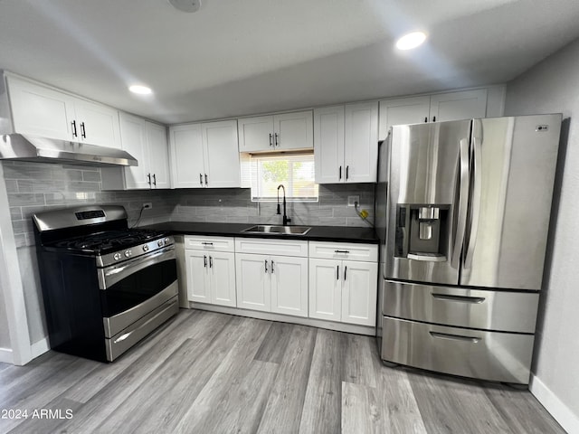 kitchen featuring white cabinets, appliances with stainless steel finishes, light hardwood / wood-style floors, and sink