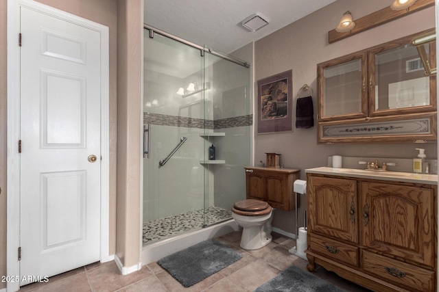 bathroom featuring a stall shower, tile patterned flooring, visible vents, and vanity