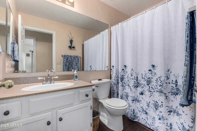 bathroom featuring vanity, toilet, and wood finished floors