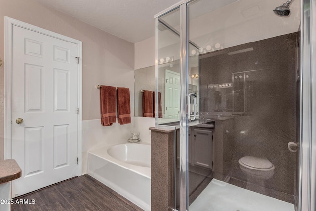 full bath featuring wood finished floors, a shower stall, and a bath