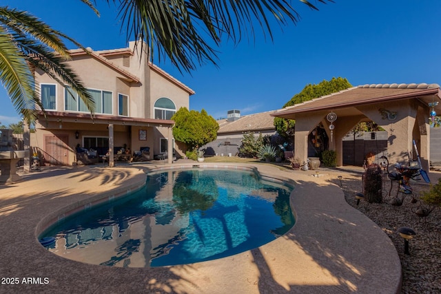 outdoor pool with a patio area and fence