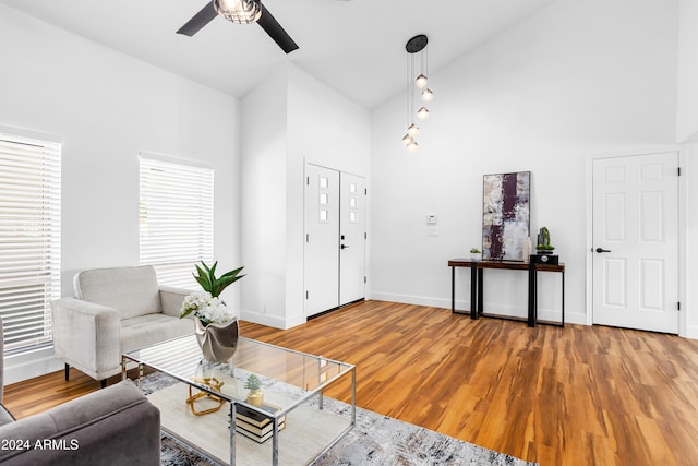 living room featuring hardwood / wood-style flooring, high vaulted ceiling, and ceiling fan