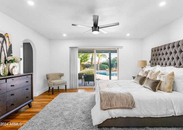 bedroom with hardwood / wood-style floors, ceiling fan, and access to outside