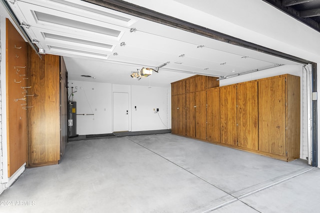 garage featuring a garage door opener and electric water heater