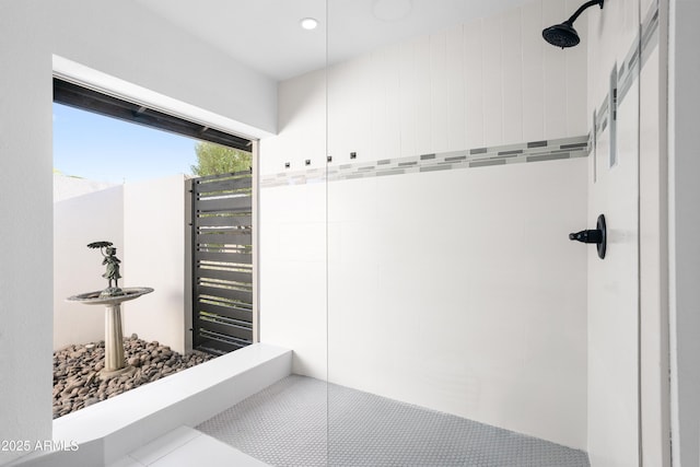 bathroom with tiled shower