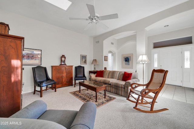 tiled living room with ceiling fan